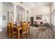 Open-concept living and dining area with wood-look tile flooring and soaring ceilings at 18001 N 53Rd St, Scottsdale, AZ 85254