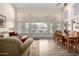 Bright living and dining area featuring large windows, wood-look floors, and comfortable seating at 18001 N 53Rd St, Scottsdale, AZ 85254
