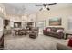 Inviting open-concept living room with plush seating, ceiling fan, and views into the kitchen at 18001 N 53Rd St, Scottsdale, AZ 85254