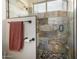 Modern shower with natural stone tile and glass door, creating a spa-like experience at 18001 N 53Rd St, Scottsdale, AZ 85254