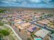 Wide shot of a neighborhood with houses, roads, and desert landscape in the background at 19684 N 260Th Ave, Buckeye, AZ 85396