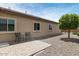 Small paved patio with two chairs, located next to a gravel area with a small tree at 19684 N 260Th Ave, Buckeye, AZ 85396