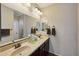 Double vanity bathroom with dark wood cabinets and tile floors at 19684 N 260Th Ave, Buckeye, AZ 85396