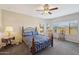 Bedroom with wood framed bed and ceiling fan at 19684 N 260Th Ave, Buckeye, AZ 85396
