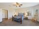 Bedroom with wood framed bed and ceiling fan at 19684 N 260Th Ave, Buckeye, AZ 85396