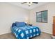 Bedroom with a blue and white comforter and nightstand at 19684 N 260Th Ave, Buckeye, AZ 85396