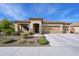 Single-story home with three-car garage and desert landscaping at 19684 N 260Th Ave, Buckeye, AZ 85396