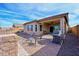 Home's exterior showcases a covered patio and built-in grill at 19684 N 260Th Ave, Buckeye, AZ 85396