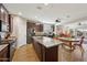 Open kitchen with island, stainless steel appliances, and Gathering room view at 19684 N 260Th Ave, Buckeye, AZ 85396