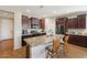 Island kitchen with dark wood cabinets and granite counters at 19684 N 260Th Ave, Buckeye, AZ 85396