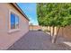 Side yard with gravel and lush green trees at 19684 N 260Th Ave, Buckeye, AZ 85396