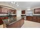 Spacious kitchen with island, stainless steel appliances, and dark wood cabinets at 20 W Cooper Canyon Rd, San Tan Valley, AZ 85143