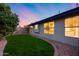 Lush backyard with grass, mature trees, and landscaping at 22852 N 103Rd Ave, Peoria, AZ 85383