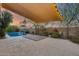 Backyard featuring an outdoor pool with waterfall and a shaded patio at 22852 N 103Rd Ave, Peoria, AZ 85383