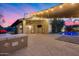 Outdoor living space with covered patio, bar area, and inviting pool, perfect for entertaining under the stars at 22852 N 103Rd Ave, Peoria, AZ 85383