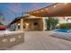 Backyard showcasing the pool, covered patio, barbeque grill, and TV at 22852 N 103Rd Ave, Peoria, AZ 85383