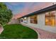 Green backyard featuring a side view of the home at 22852 N 103Rd Ave, Peoria, AZ 85383