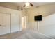 Bedroom with a ceiling fan, closet, and TV mounted to the wall at 22852 N 103Rd Ave, Peoria, AZ 85383