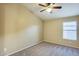 View of empty bedroom featuring neutral carpet, ceiling fan, and natural light at 22852 N 103Rd Ave, Peoria, AZ 85383