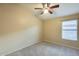 Neutral bedroom with carpet, a ceiling fan, and a window at 22852 N 103Rd Ave, Peoria, AZ 85383