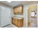 Butler's pantry with wooden cabinets, countertop space, and a doorway to another room at 22852 N 103Rd Ave, Peoria, AZ 85383