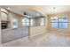 Dining area featuring tile floors, a chandelier, and a view of the living area with a fireplace at 22852 N 103Rd Ave, Peoria, AZ 85383