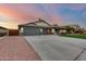 Attractive single-story residence boasting a large driveway, tidy landscaping, and a three-car garage at 22852 N 103Rd Ave, Peoria, AZ 85383