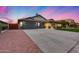 Attractive single-story home with a large driveway, attractive landscaping, and a spacious three-car garage at 22852 N 103Rd Ave, Peoria, AZ 85383
