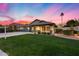 Elegant single-story property featuring a manicured lawn, attractive landscaping, and an oversized driveway at 22852 N 103Rd Ave, Peoria, AZ 85383