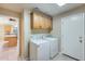 Convenient laundry room with a washer, dryer, and overhead cabinets at 22852 N 103Rd Ave, Peoria, AZ 85383