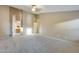 Spacious living room with carpet and an arched entryway to bathroom at 22852 N 103Rd Ave, Peoria, AZ 85383