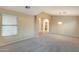 Expansive living room with carpet, arched doorway, and bright natural light at 22852 N 103Rd Ave, Peoria, AZ 85383