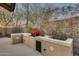 Built-in barbeque grill featuring desert landscaping and ample counter space at 22852 N 103Rd Ave, Peoria, AZ 85383