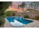 Beautiful backyard pool featuring a waterfall and lush landscaping at sunset at 22852 N 103Rd Ave, Peoria, AZ 85383