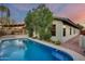 Backyard pool adjacent to house with mature landscaping and covered patio at 22852 N 103Rd Ave, Peoria, AZ 85383