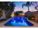 Relaxing pool with gentle waterfalls, lush landscaping, and soft lighting to create an oasis of calm at 22852 N 103Rd Ave, Peoria, AZ 85383