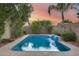 Inviting backyard pool with waterfall feature surrounded by mature landscaping at 22852 N 103Rd Ave, Peoria, AZ 85383