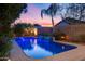 Sparkling blue pool featuring a tranquil waterfall and landscaped surroundings offering a serene escape at 22852 N 103Rd Ave, Peoria, AZ 85383