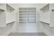 A large walk-in closet with adjustable shelves and carpeted flooring at 22852 N 103Rd Ave, Peoria, AZ 85383