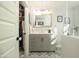 Updated bathroom with gray vanity and patterned floor tile at 28 E Hoover Ave, Phoenix, AZ 85004