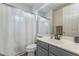 Clean bathroom features a shower with a white curtain, gray vanity with white countertop, and modern fixtures at 3095 S Ironwood St, Gilbert, AZ 85295