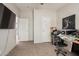 Bedroom with large TV, workspace, and ample closet space at 3315 N Datura Ct, Maricopa, AZ 85139