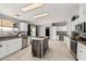 Modern kitchen with white cabinets and a large island at 3315 N Datura Ct, Maricopa, AZ 85139