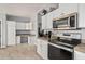 Bright kitchen with white cabinets, stainless steel appliances, and built-in desk at 3315 N Datura Ct, Maricopa, AZ 85139