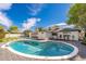 A refreshing swimming pool is surrounded by a patio and lush landscaping in the backyard at 338 E Elm St, Phoenix, AZ 85012