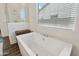 Clean bathroom with a free-standing bathtub and window at 3891 W Talc Dr, San Tan Valley, AZ 85144