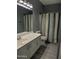 Clean bathroom with white vanity and striped shower curtain at 4330 E South Fork Dr, Phoenix, AZ 85044