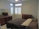 Spacious bedroom with large windows and wood dresser at 4330 E South Fork Dr, Phoenix, AZ 85044