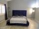 Main bedroom with a large bed and navy blue velvet headboard at 4330 E South Fork Dr, Phoenix, AZ 85044