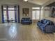 Spacious living room with two blue velvet sofas and large windows at 4330 E South Fork Dr, Phoenix, AZ 85044